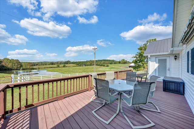 deck with a lawn and a water view