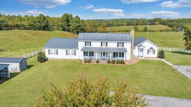 view of front of house with a front lawn and an outdoor structure