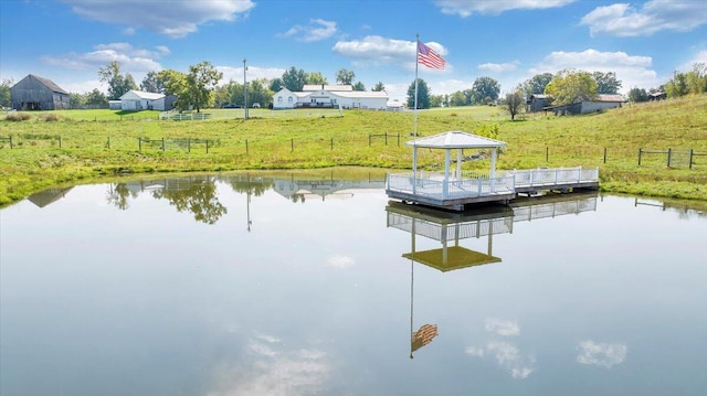 view of dock featuring a rural view, a water view, and a gazebo