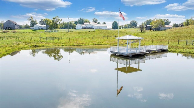 view of dock with a gazebo, a rural view, and a water view