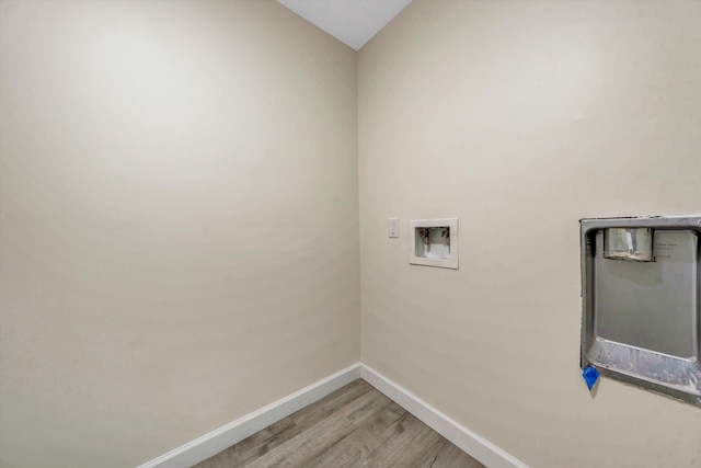 laundry area with light hardwood / wood-style floors and hookup for a washing machine