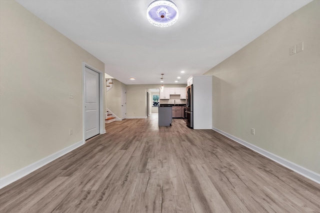 unfurnished living room featuring light hardwood / wood-style floors