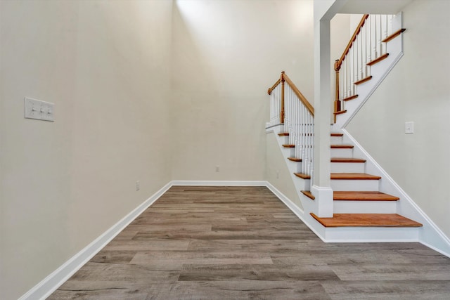 stairway featuring hardwood / wood-style flooring