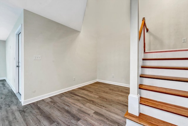 stairway with hardwood / wood-style flooring