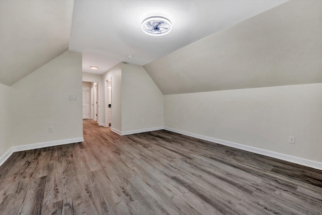 additional living space featuring light hardwood / wood-style floors and vaulted ceiling