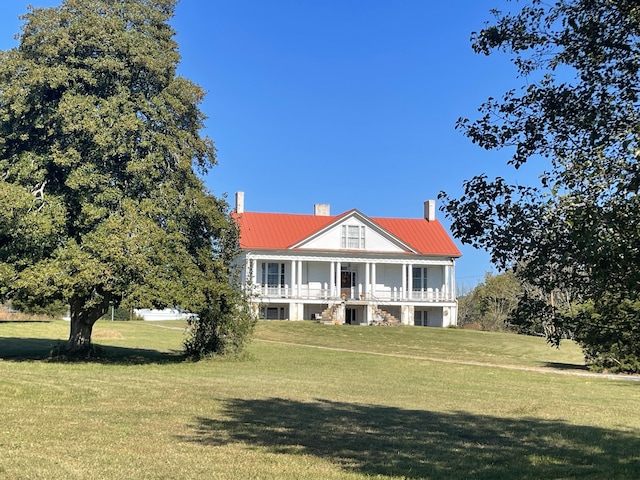 view of front of home with a porch and a front yard