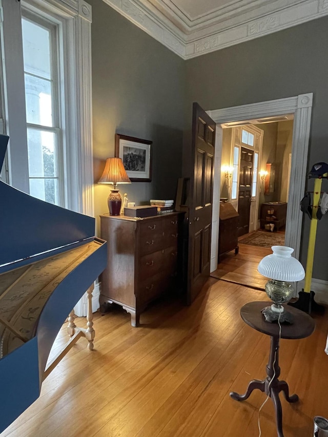 bedroom with light wood-type flooring and ornamental molding