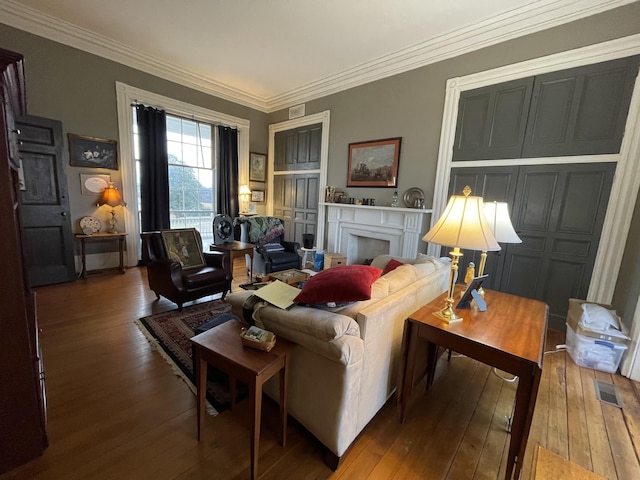 sitting room featuring hardwood / wood-style floors and crown molding