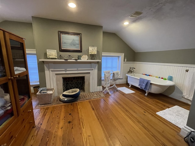 interior space featuring wood-type flooring and vaulted ceiling