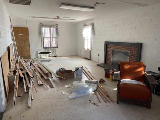 living room featuring a brick fireplace