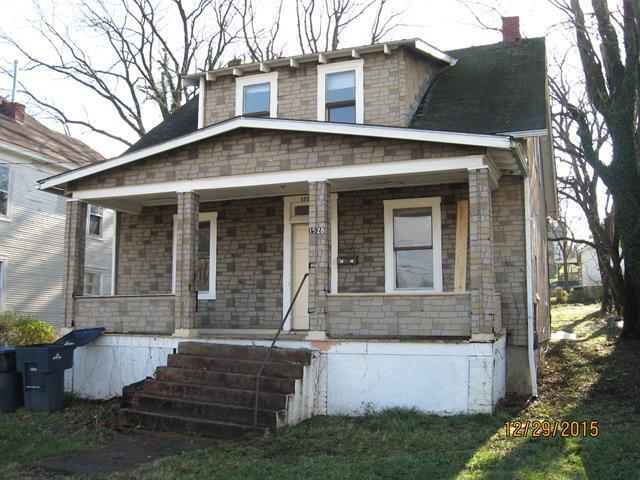 bungalow-style house with a porch and a chimney