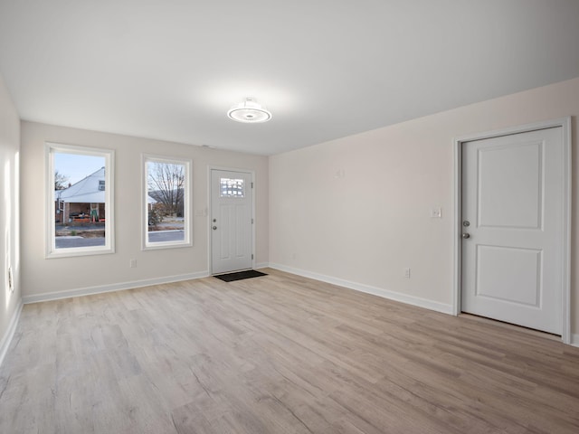 foyer entrance with light hardwood / wood-style floors