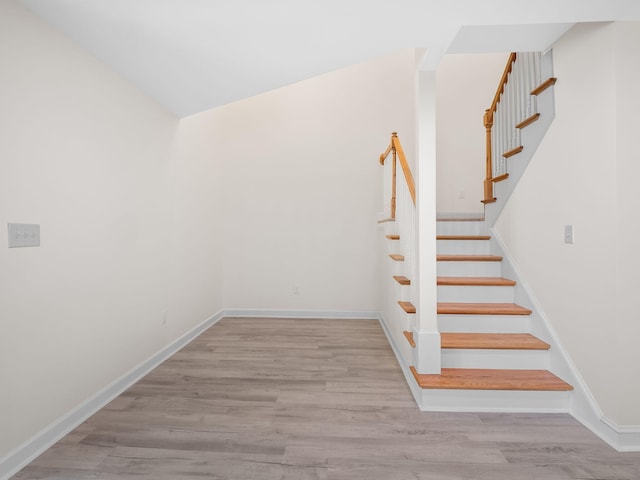 staircase with hardwood / wood-style flooring