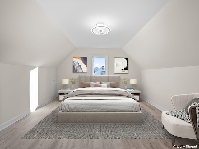 bedroom featuring vaulted ceiling and light hardwood / wood-style flooring