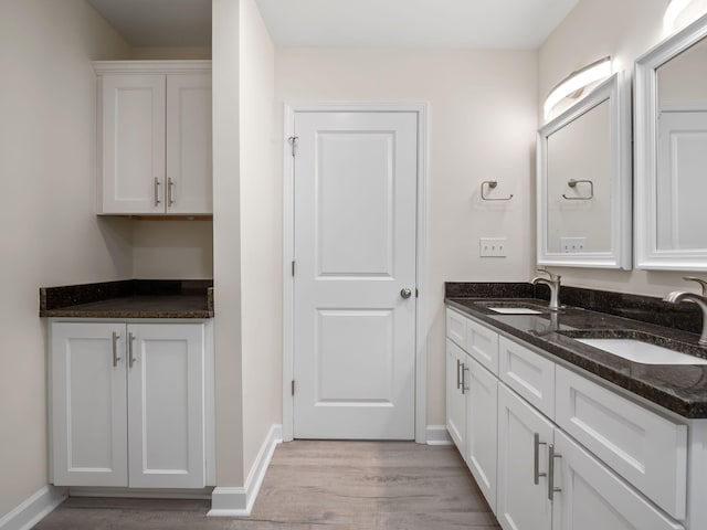 bathroom with hardwood / wood-style flooring and double sink vanity