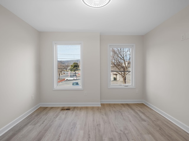 spare room featuring light hardwood / wood-style floors