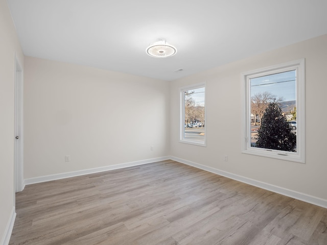 spare room with light hardwood / wood-style flooring