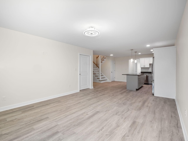 unfurnished living room with light hardwood / wood-style floors