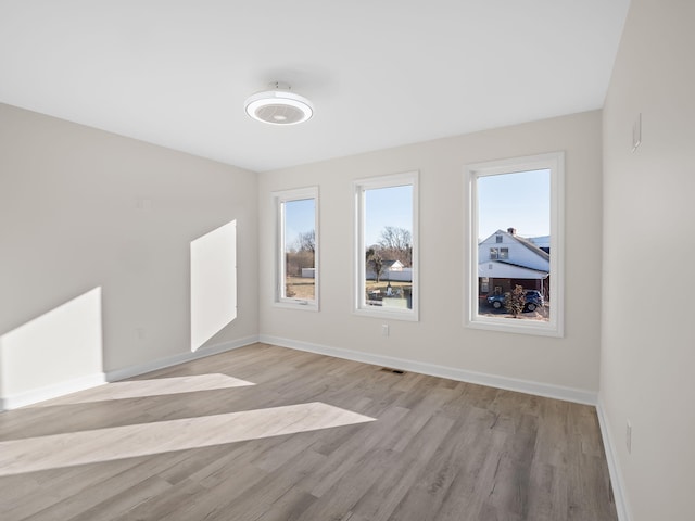 unfurnished room with light wood-type flooring