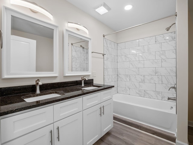 bathroom featuring hardwood / wood-style floors, vanity, and tiled shower / bath