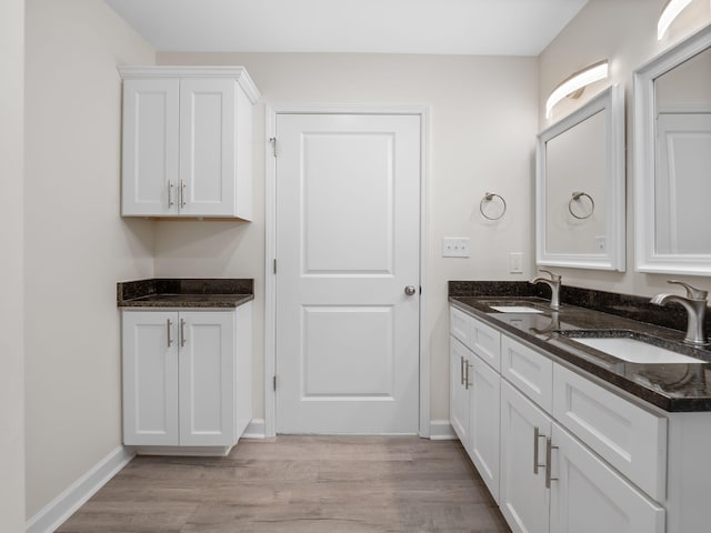 bathroom with vanity and hardwood / wood-style flooring