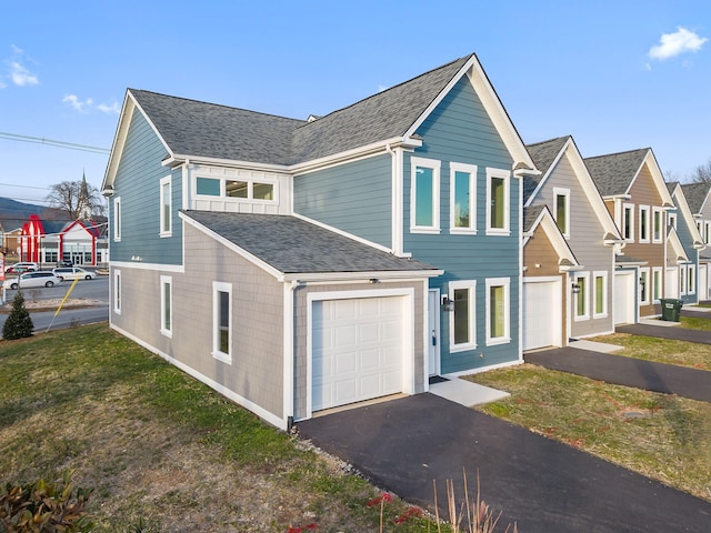 view of front facade featuring a front yard and a garage