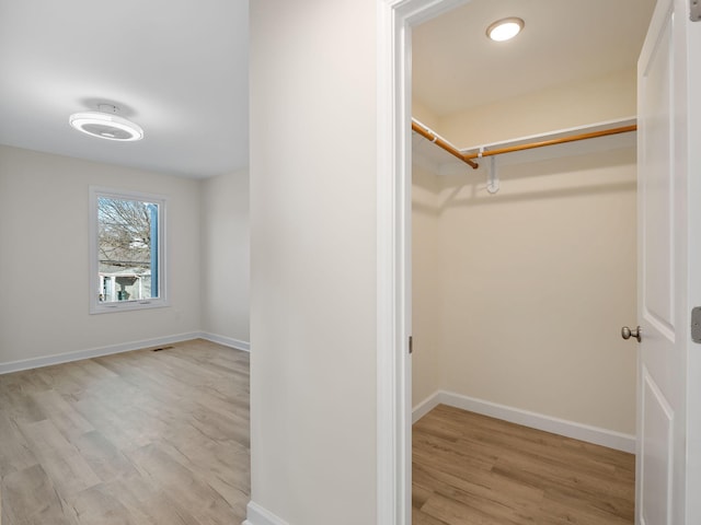 spacious closet with light hardwood / wood-style floors