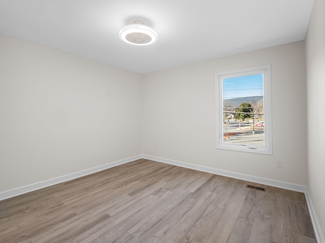 unfurnished room with light wood-type flooring