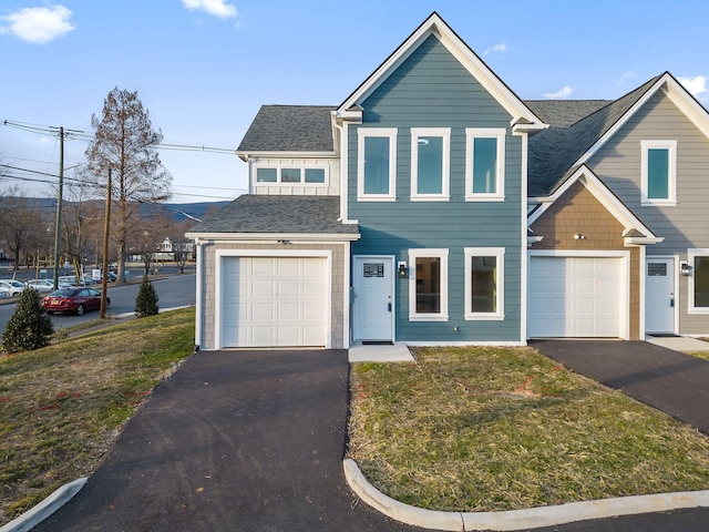 view of front of house with a front yard and a garage