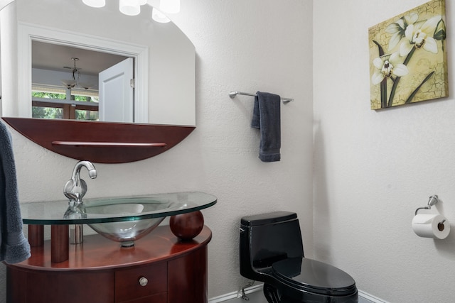 bathroom featuring toilet and vanity