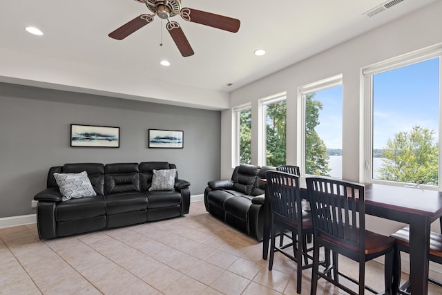 tiled living room with ceiling fan