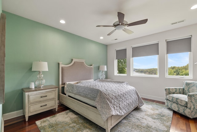 bedroom with ceiling fan and dark hardwood / wood-style floors