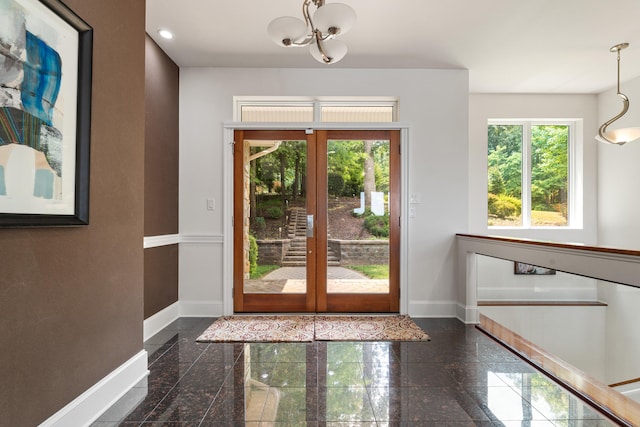 entryway featuring french doors and an inviting chandelier