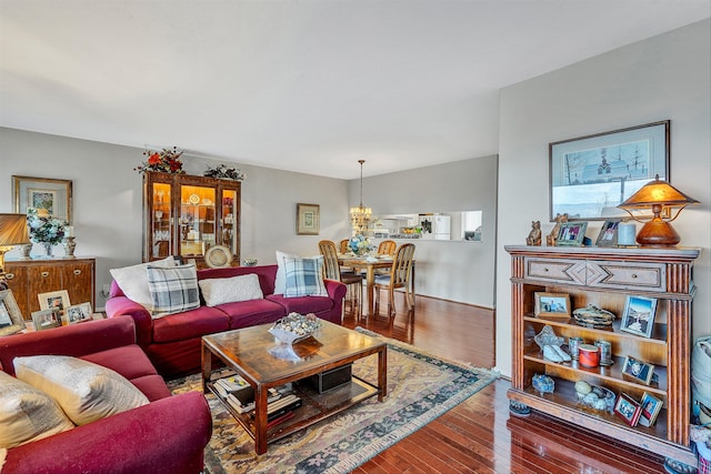 living room featuring an inviting chandelier and hardwood / wood-style floors