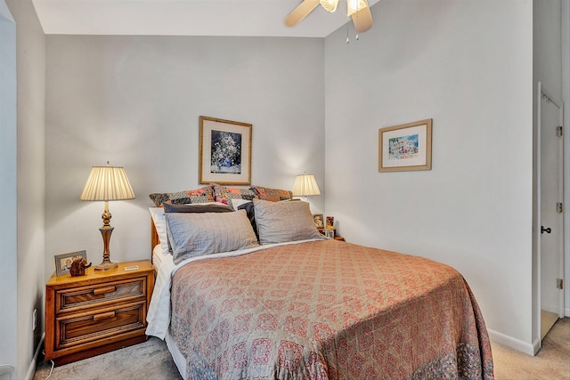 carpeted bedroom featuring vaulted ceiling and ceiling fan