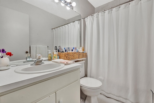 bathroom with tile floors, toilet, and large vanity