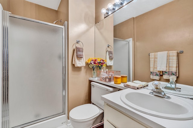 bathroom featuring toilet, vanity, and an enclosed shower