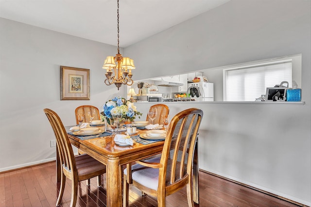 dining area with a notable chandelier and dark wood-type flooring