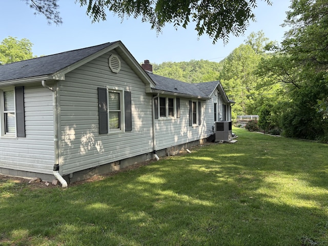 4007 Callaghan Cir, Covington, VA 24426 - view of side of property with a lawn, a shingled roof, cooling unit, and a chimney