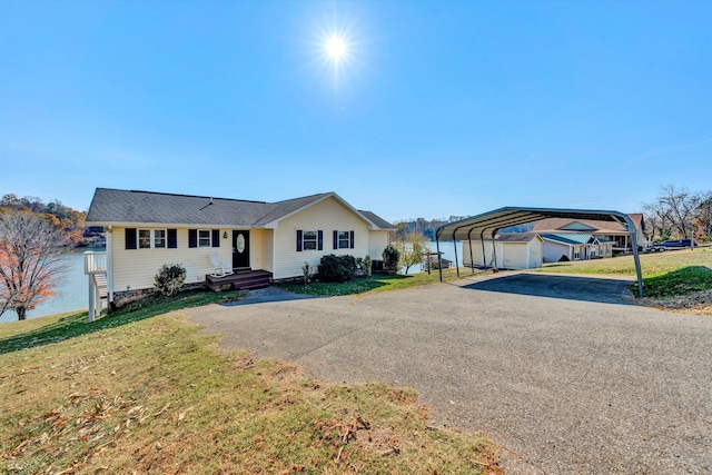 ranch-style house featuring a front lawn and a carport