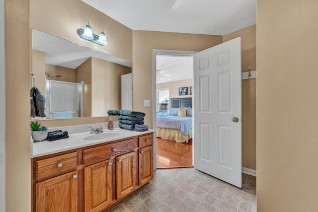 bathroom featuring an enclosed shower, wood-type flooring, ceiling fan, and vanity with extensive cabinet space