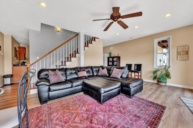 living room with ceiling fan and light wood-type flooring