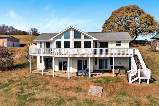 back of property with a yard and a patio