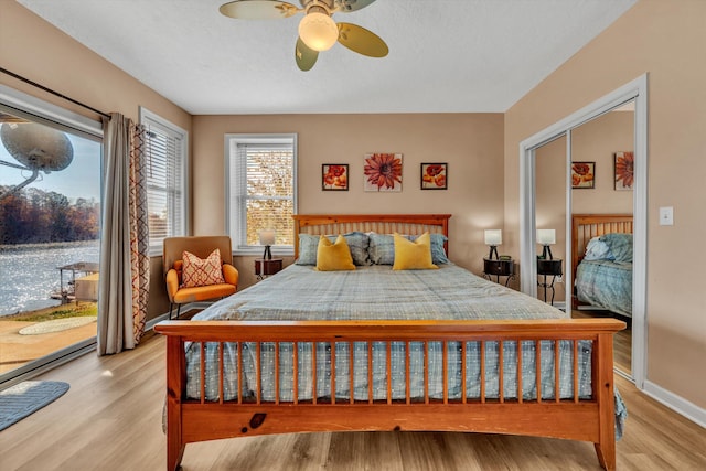 bedroom featuring a closet, ceiling fan, and light wood-type flooring