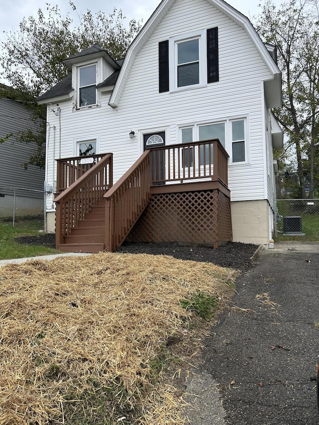 back of house with a wooden deck