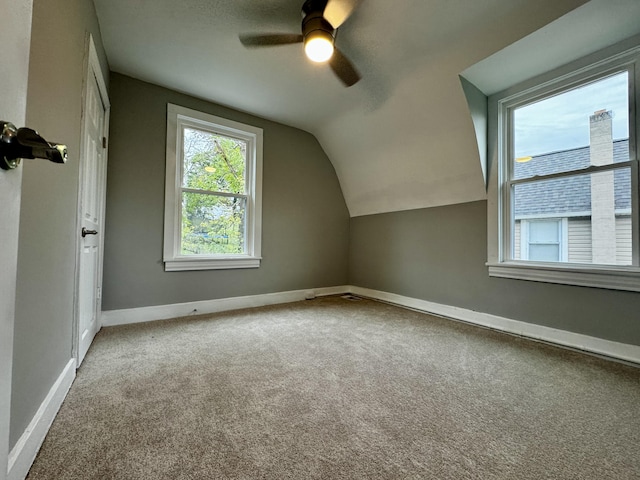 additional living space with ceiling fan, vaulted ceiling, and carpet flooring