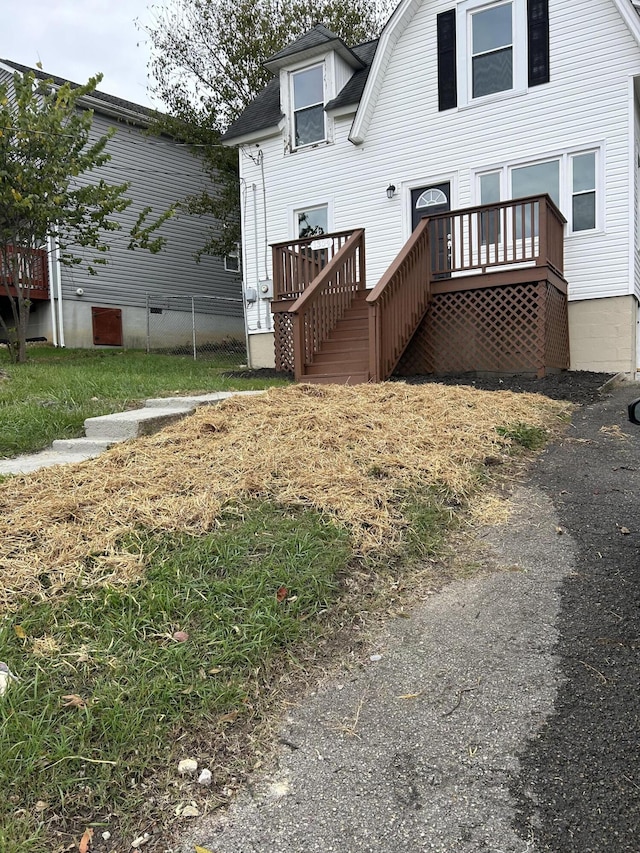 rear view of property with a wooden deck