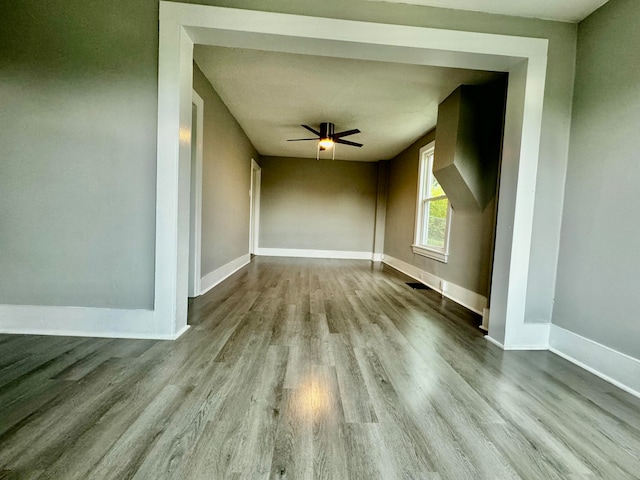 empty room with light wood-type flooring and ceiling fan