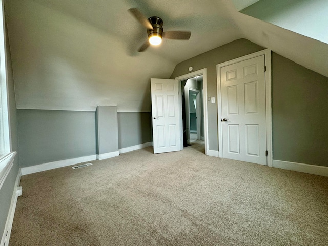 bonus room featuring ceiling fan, carpet floors, and vaulted ceiling