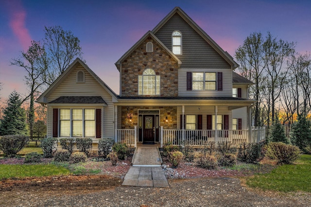 view of front of house with covered porch and stone siding